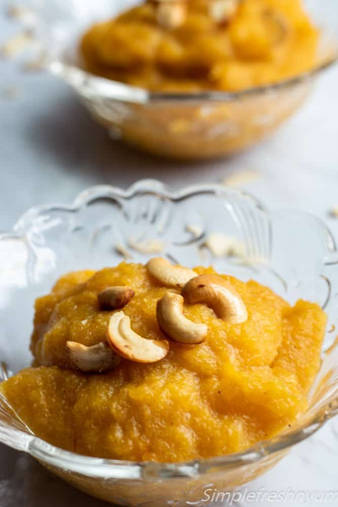 Apple pumpkin halwa in two glass bowls with ghee roasted nuts on top