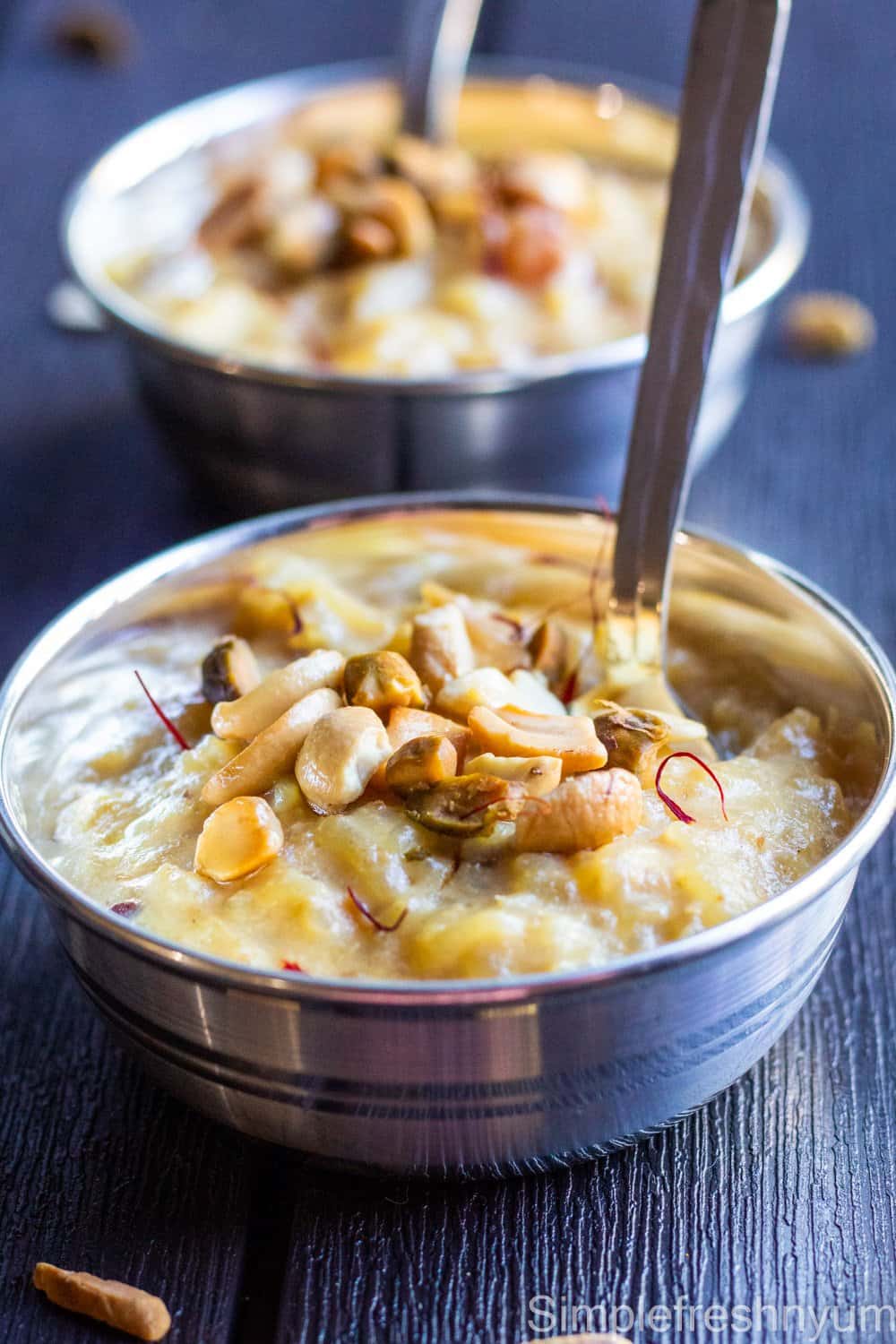 Instant pot rice kheer in silver color serving bowls garnished with nuts and saffron on top.