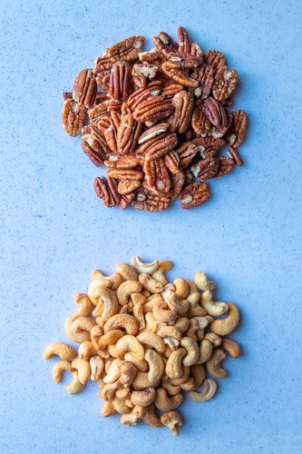 Cashews and Pecans on a white surface ready for the recipe