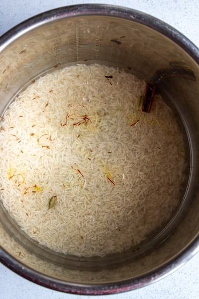 Basmati Rice soaking with all the ingredients added in the Instant pot inner pot in 8 Qt.