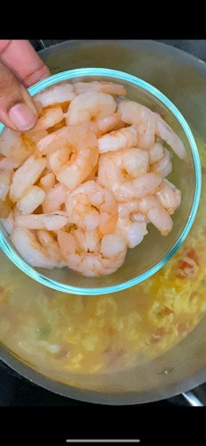 Adding defrosted cooked shrimp to the soup