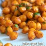 Close up image of Indian roasted chickpeas on a white surface.